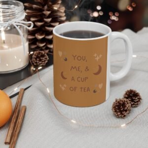 A product image of a white the Sweet Embrace Mug with a C-shaped handle, filled with a warm beverage